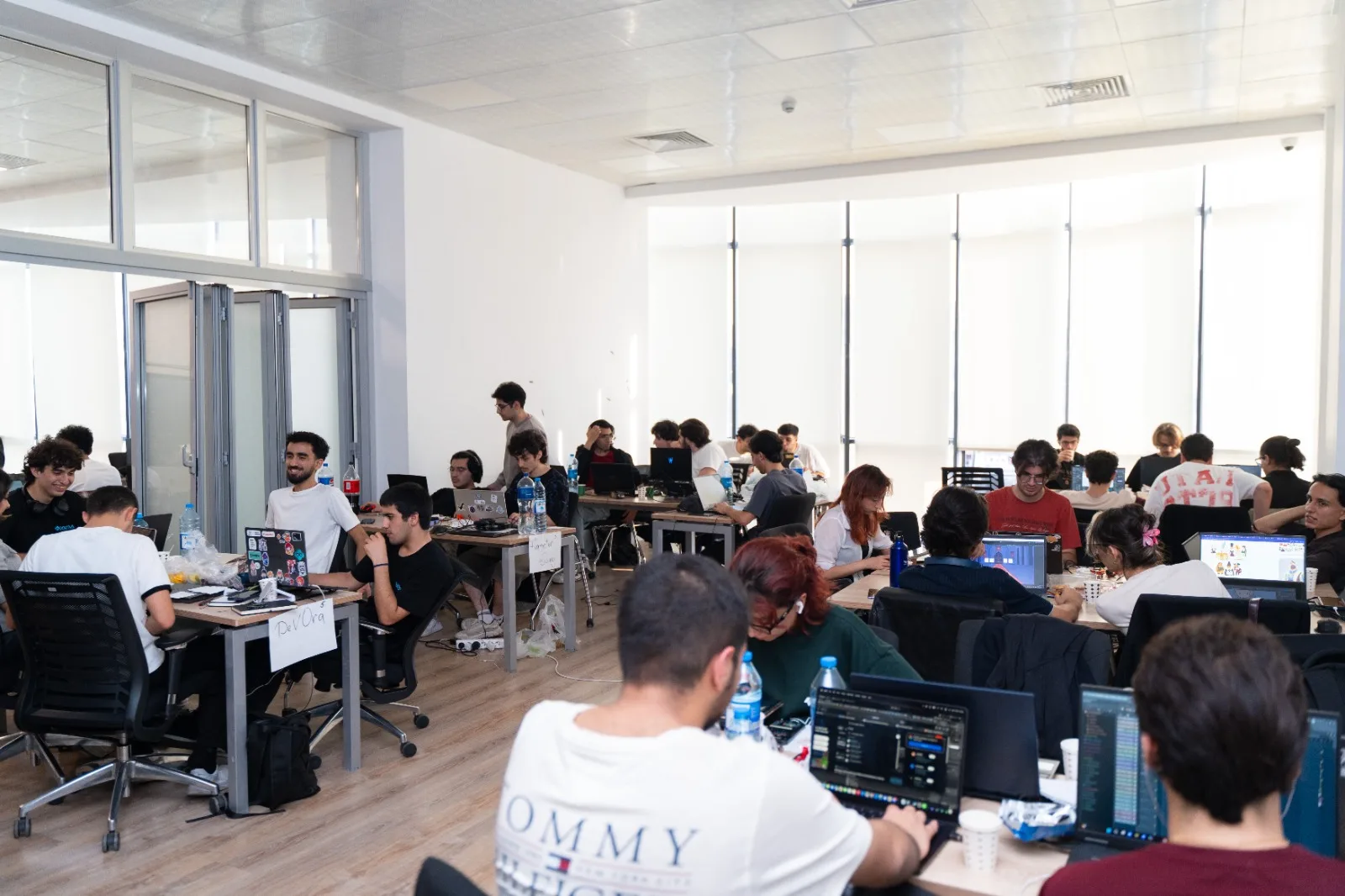 Teams working at their tables on the INNOLAND floor during GameJamPlus 2026/27 Azerbaijan
